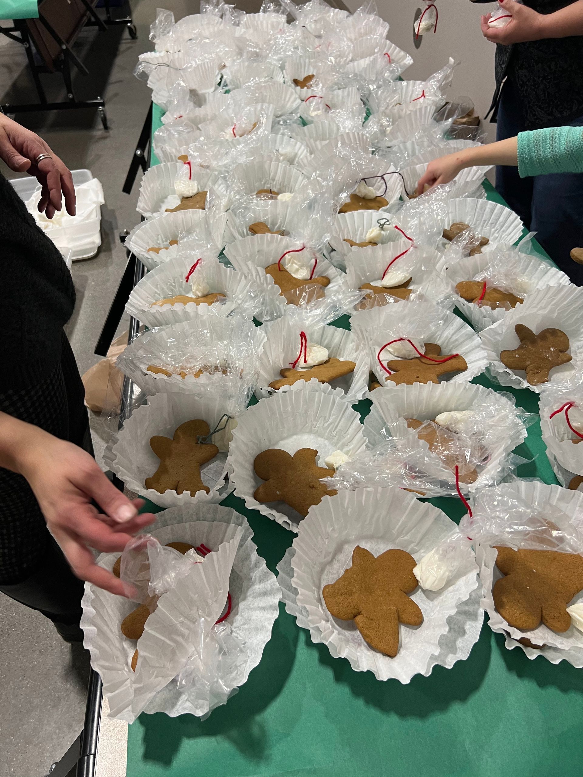 A table full of gingerbread cookies in cupcake liners