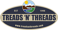 A logo for treads n threads with a river and mountains on it.