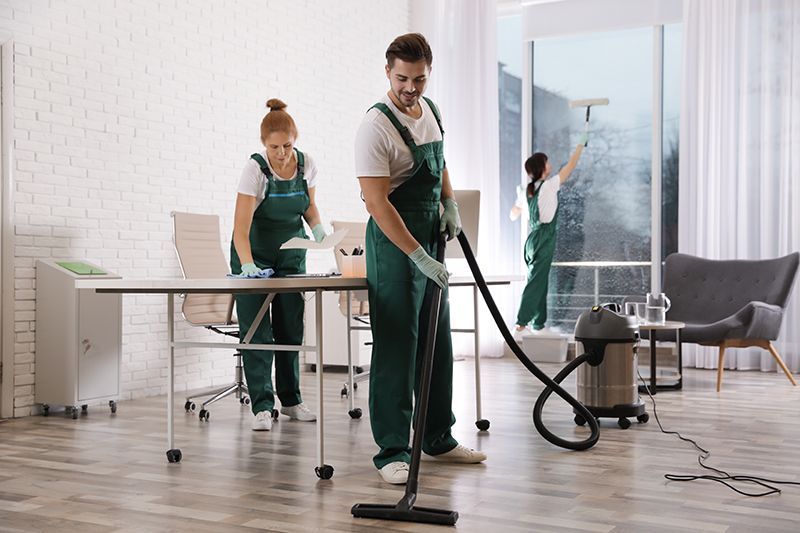 Workers Cleaning The Modern Office