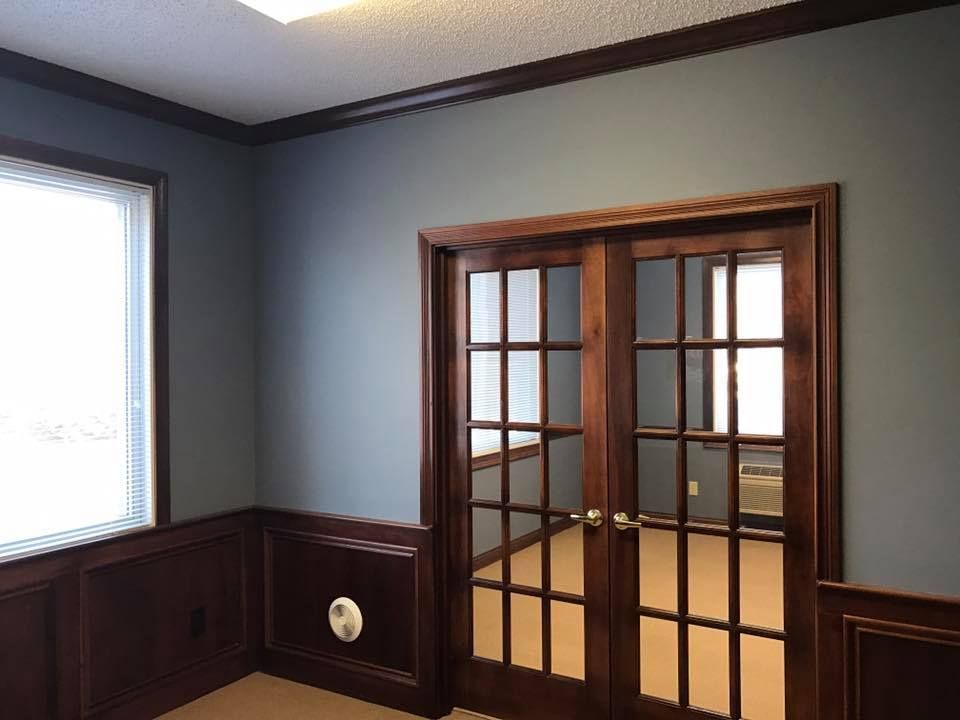 An empty room with french doors and a window