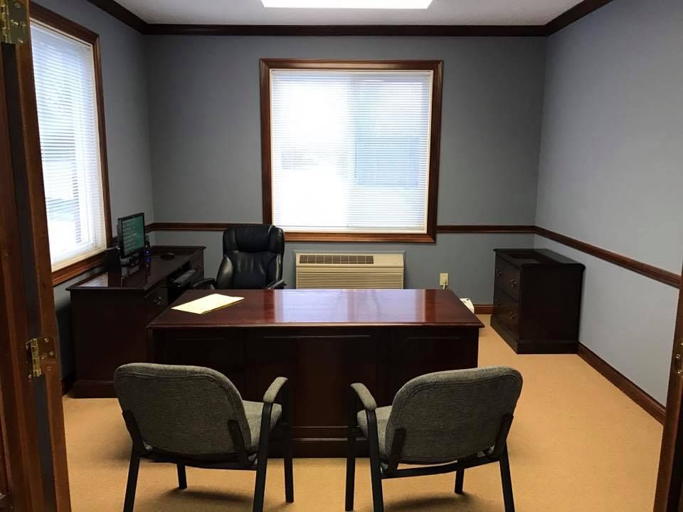 A small office with two chairs and a desk