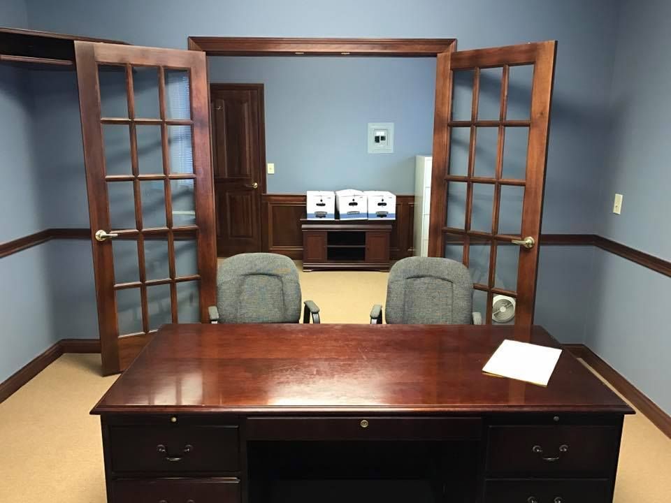 An empty office with a desk and two chairs