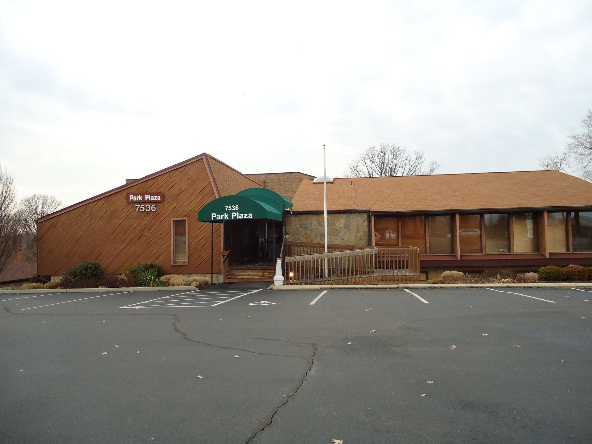 A large brown building with a green awning over the entrance