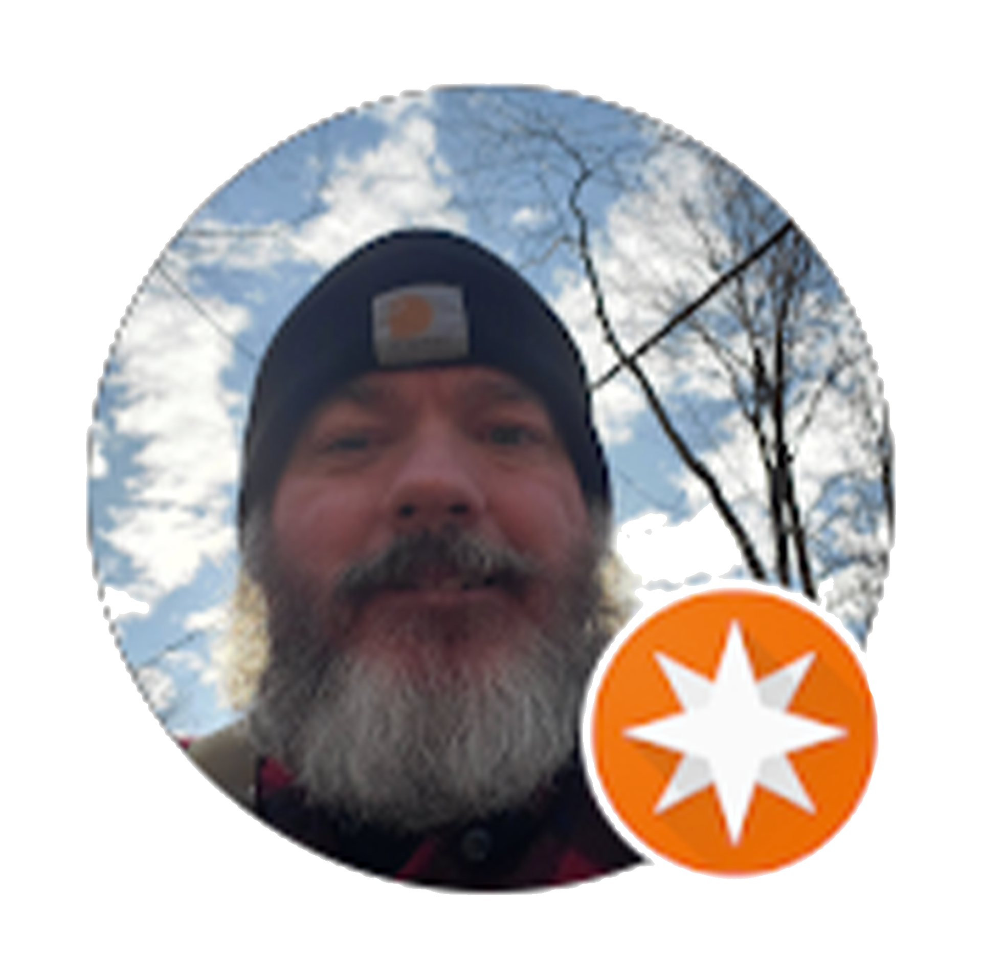 Man with a gray beard and black hat outside under a cloudy sky, with a white and orange star logo.