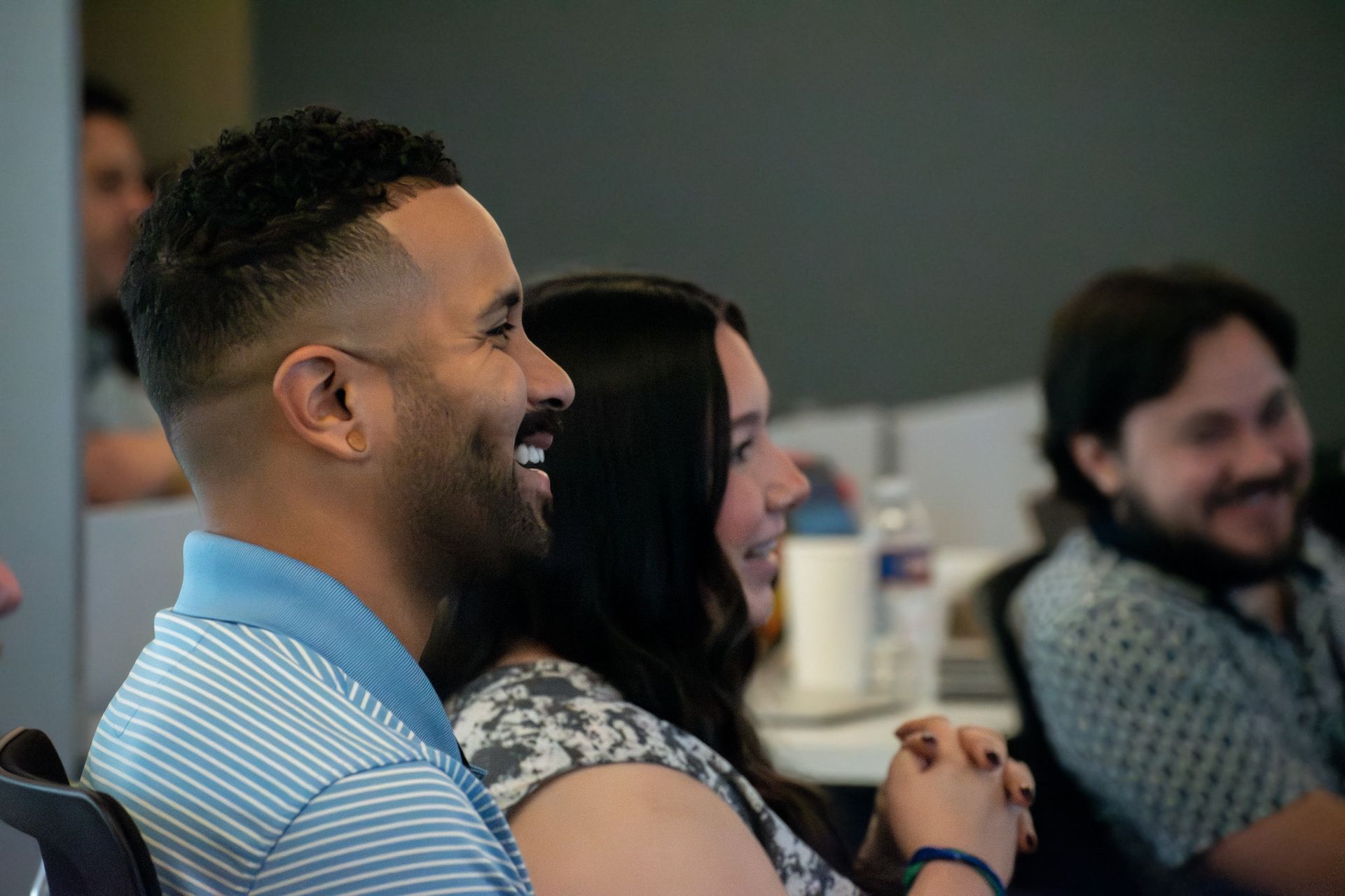 A man and a woman are sitting next to each other and smiling.