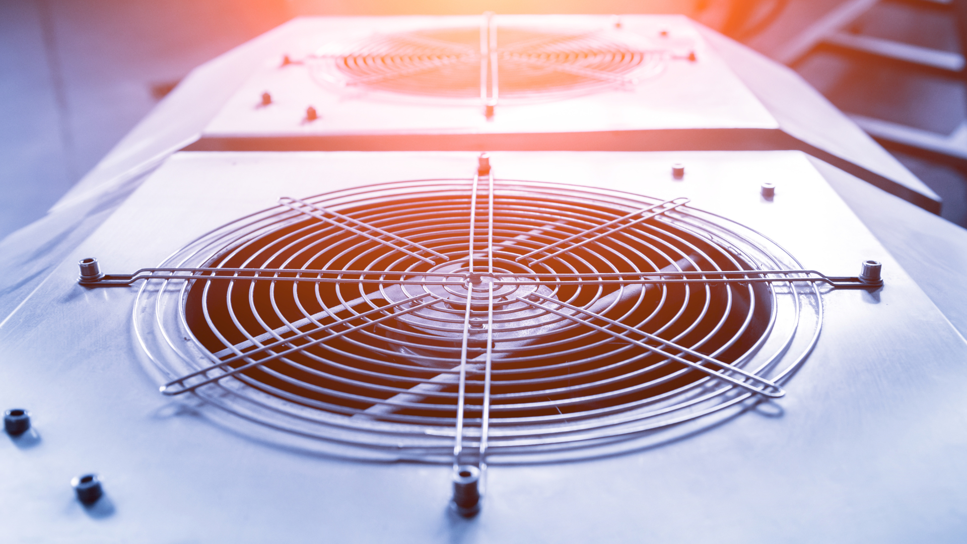 A close up of a fan on top of a building.