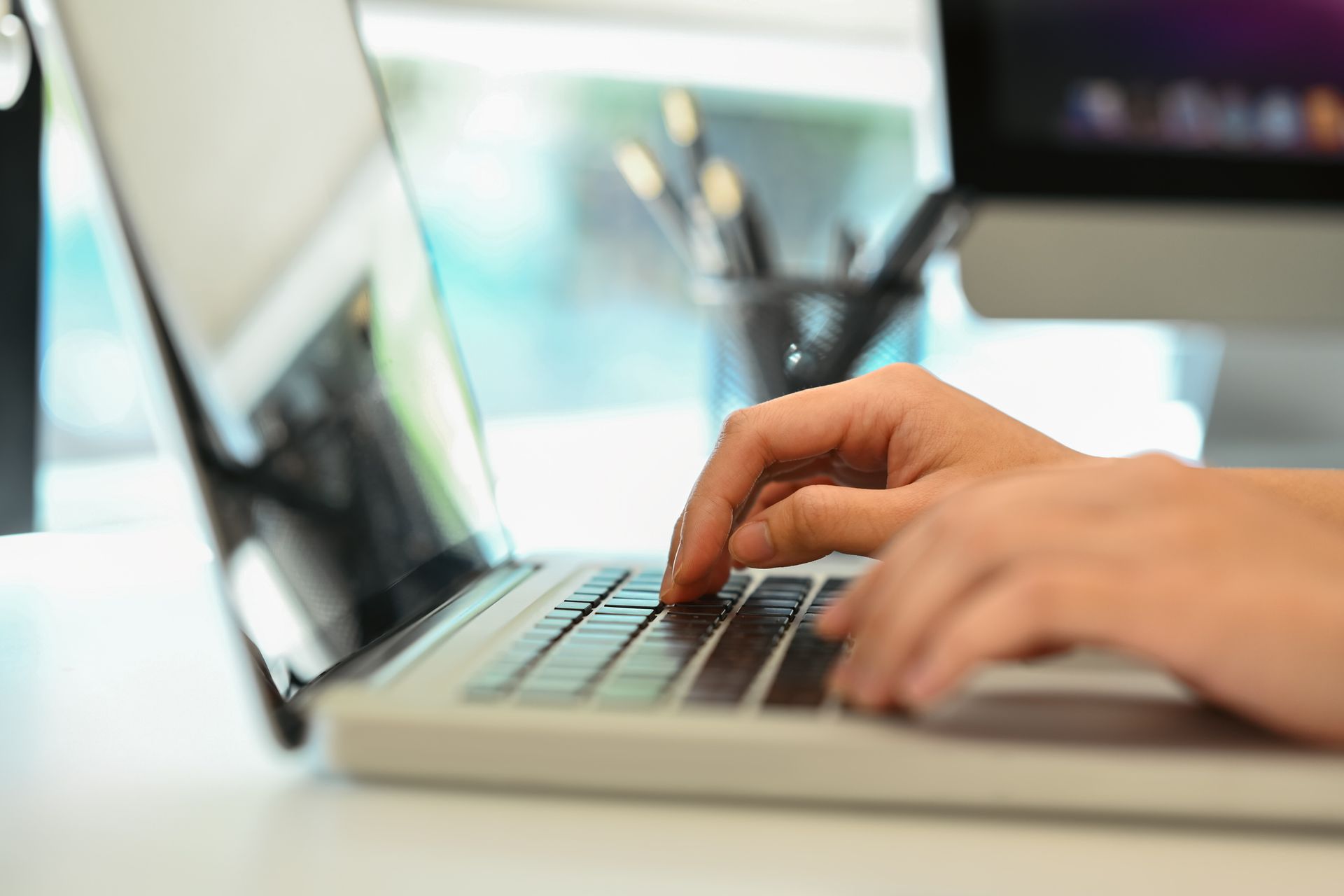 Person typing on a computer.