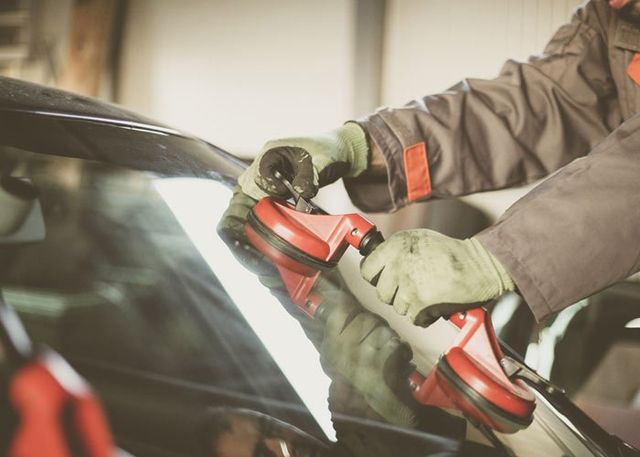 Auto Glass — Mechanic Changing Glass on Car in San Antonio, TX Auto Glass — Mechanic Changing Glass on Car in San Antonio, TX