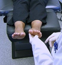 Foot Injury — Doctor Checking the Foot of Woman Patient in Reno, NV