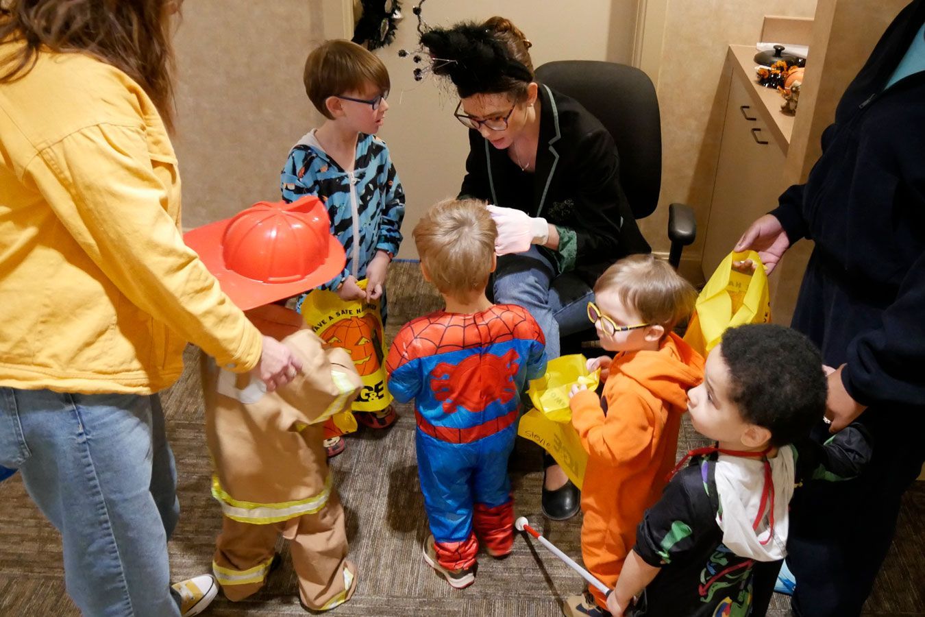 Miss Paige hands out treats to the kids.
