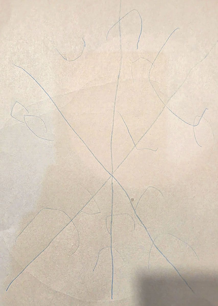 A child-made snowflake with six points and semicircles on the ends drawn with blue marker.