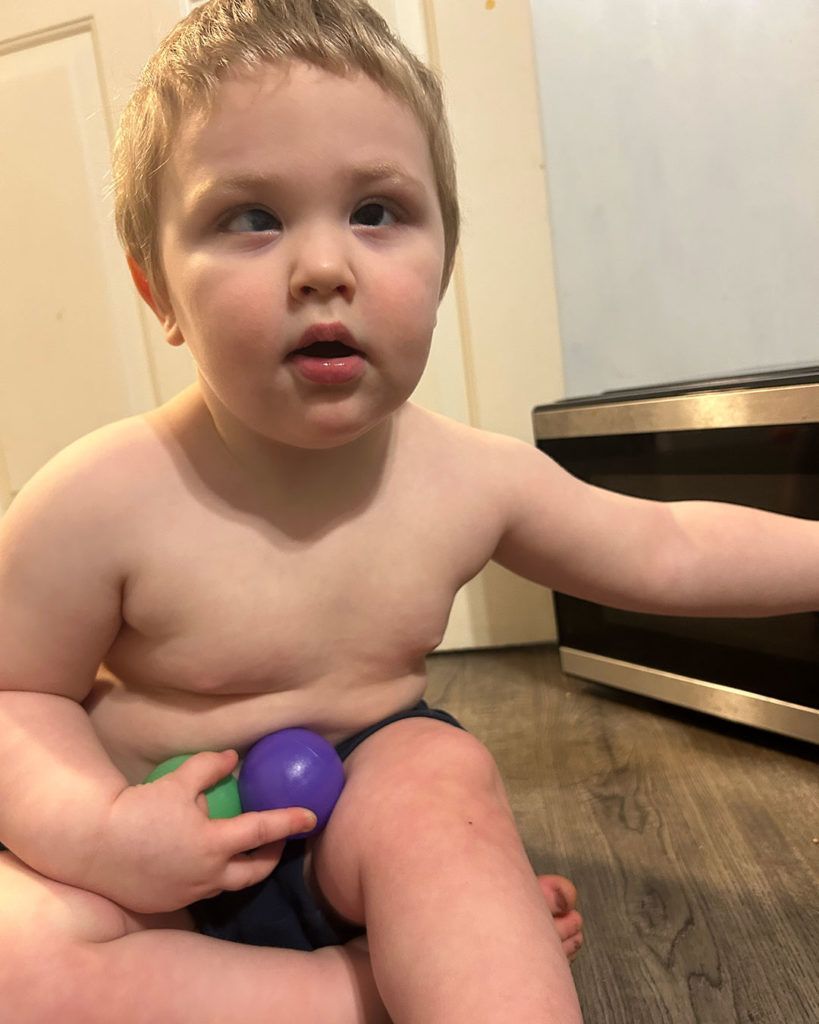 Phoenix is sitting on the floor and posing for a photo.