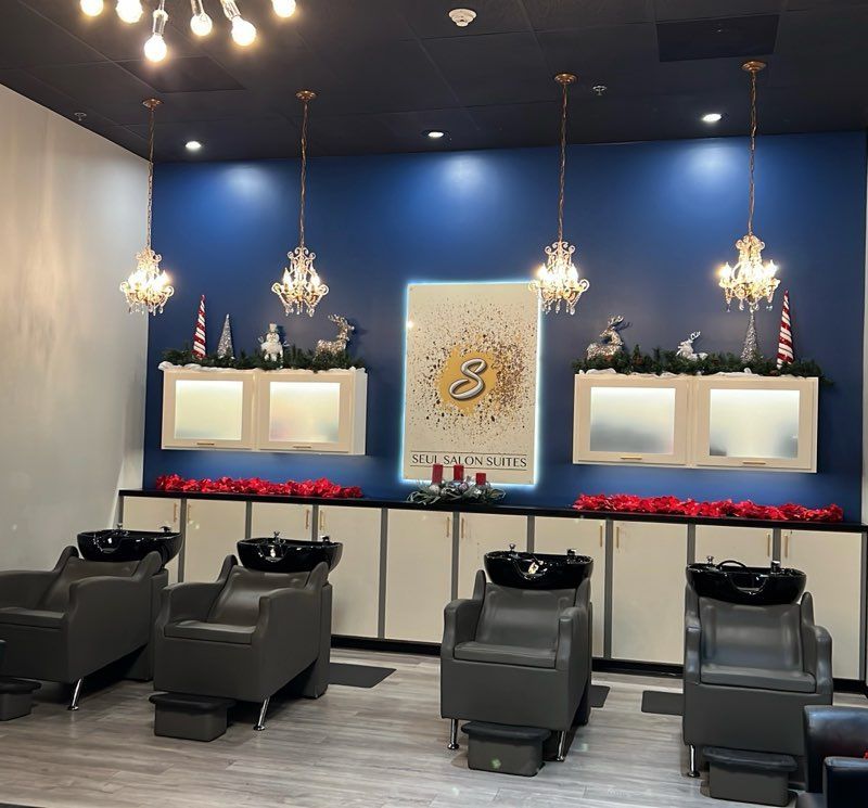 A row of mannequins wearing wigs in a store.