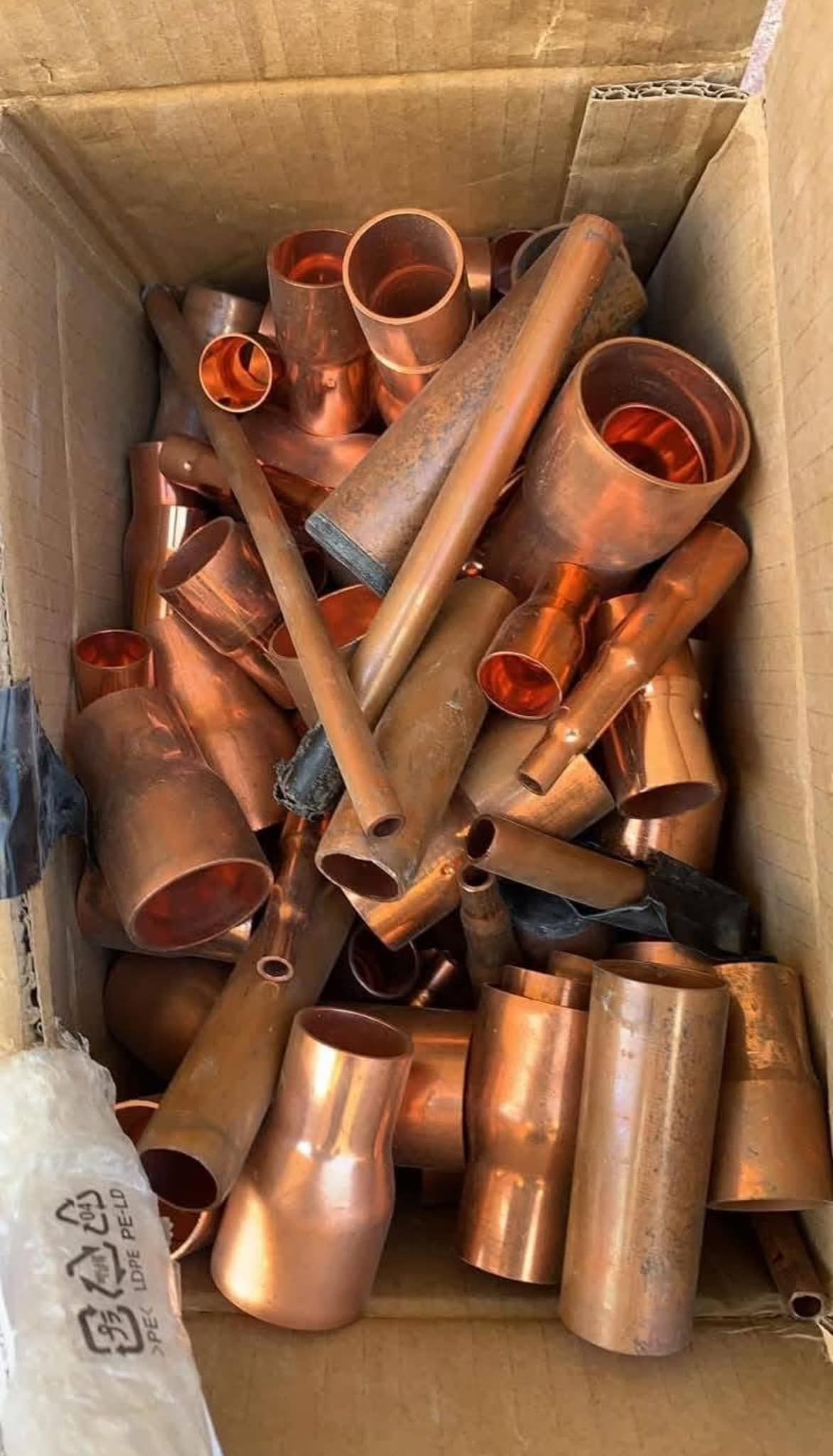 Box of copper pipes and fittings.