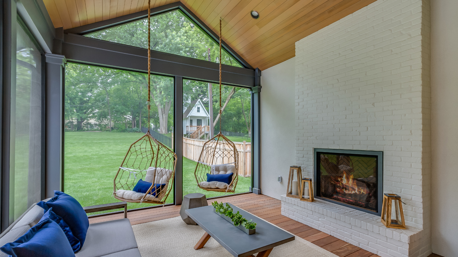 a living room with a fireplace and hanging chairs .