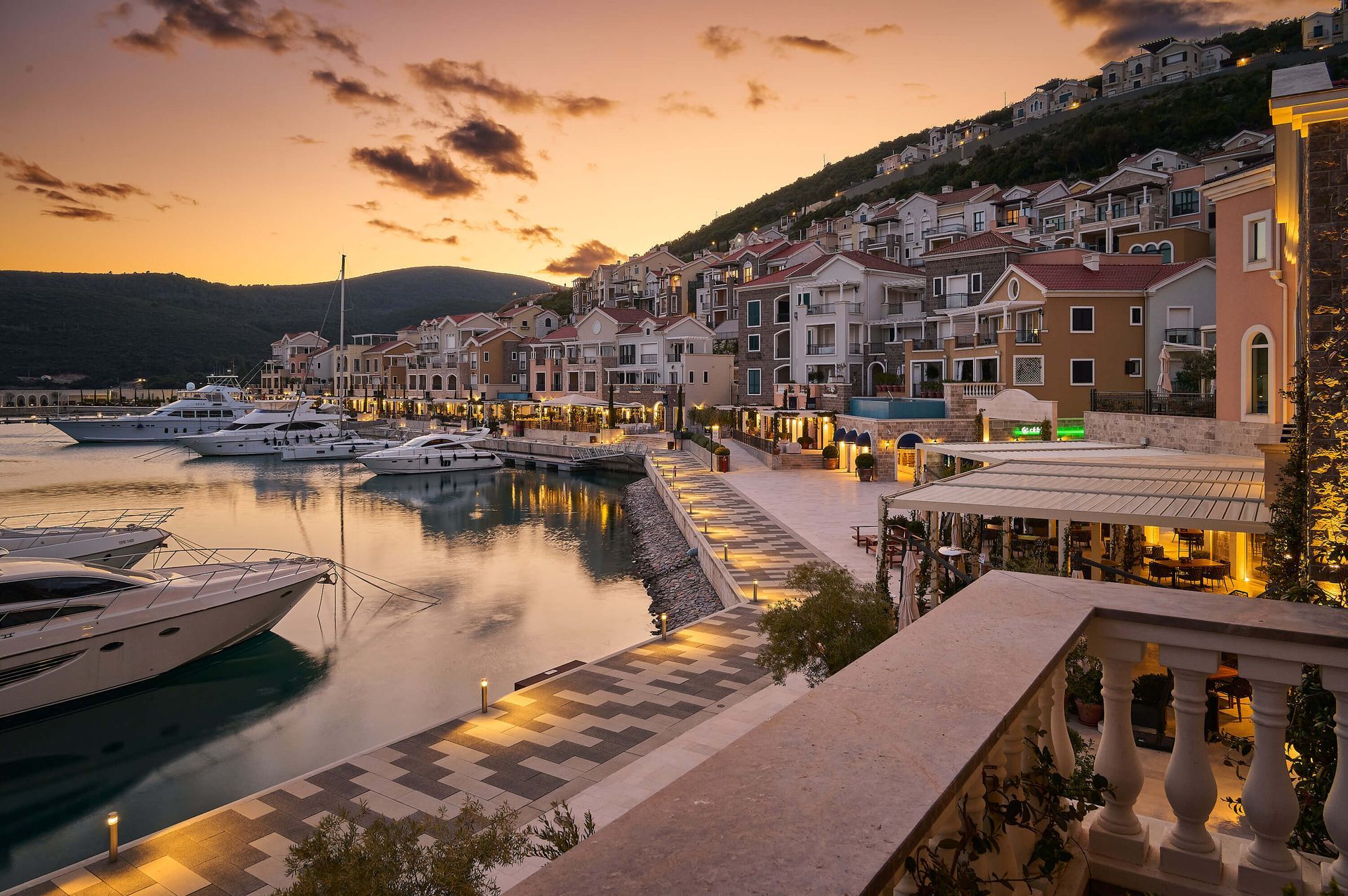 A harbor with boats and buildings at sunset