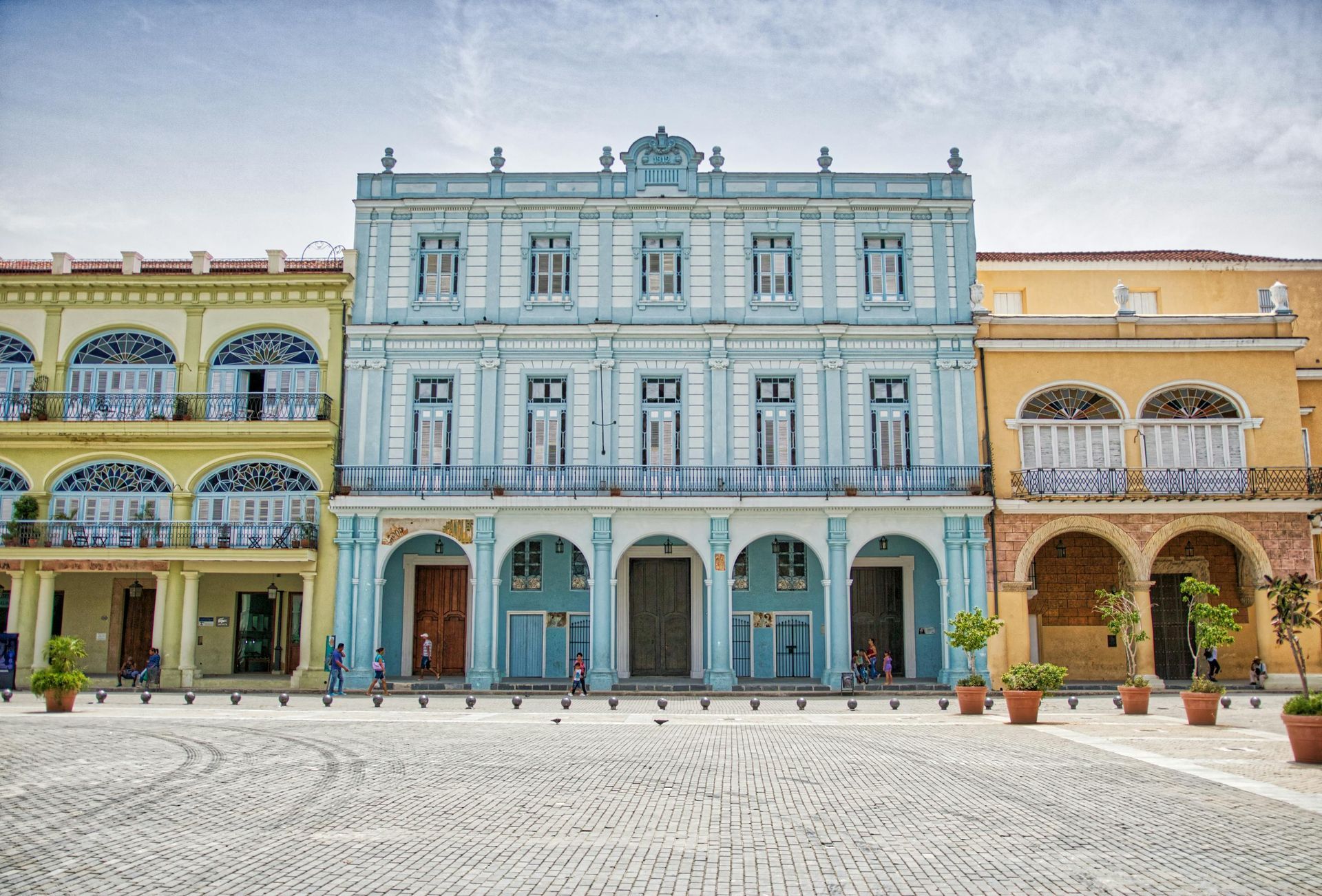 A row of colorful buildings are lined up in a square.
