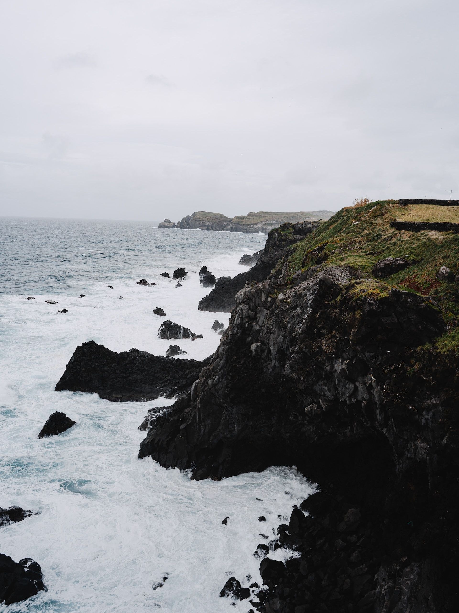 A rocky cliff overlooking a body of water