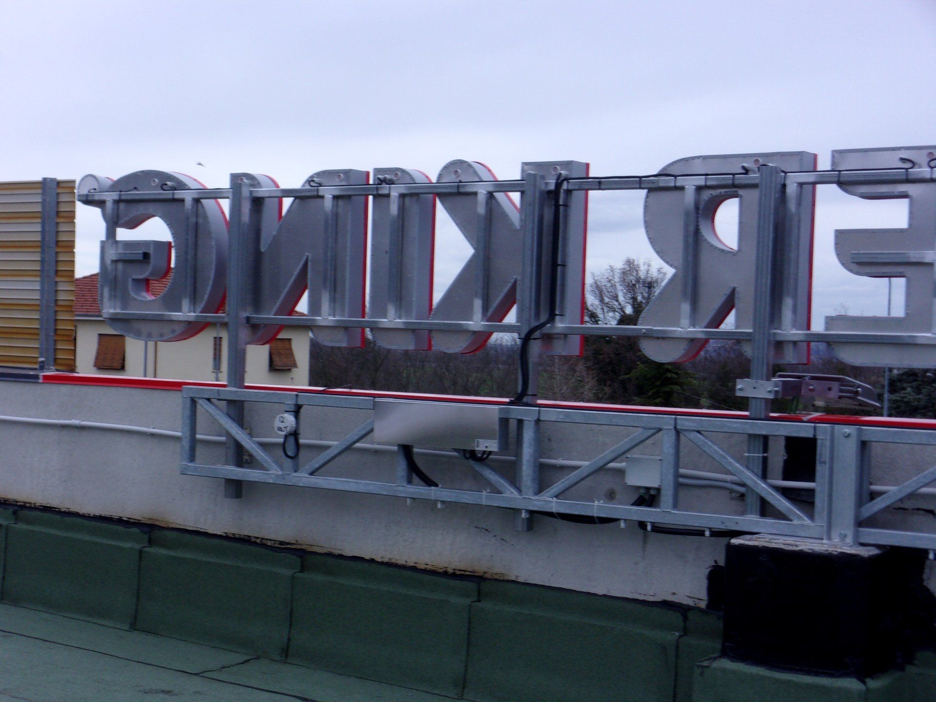 Cartello argentato sul tetto, con la scritta 