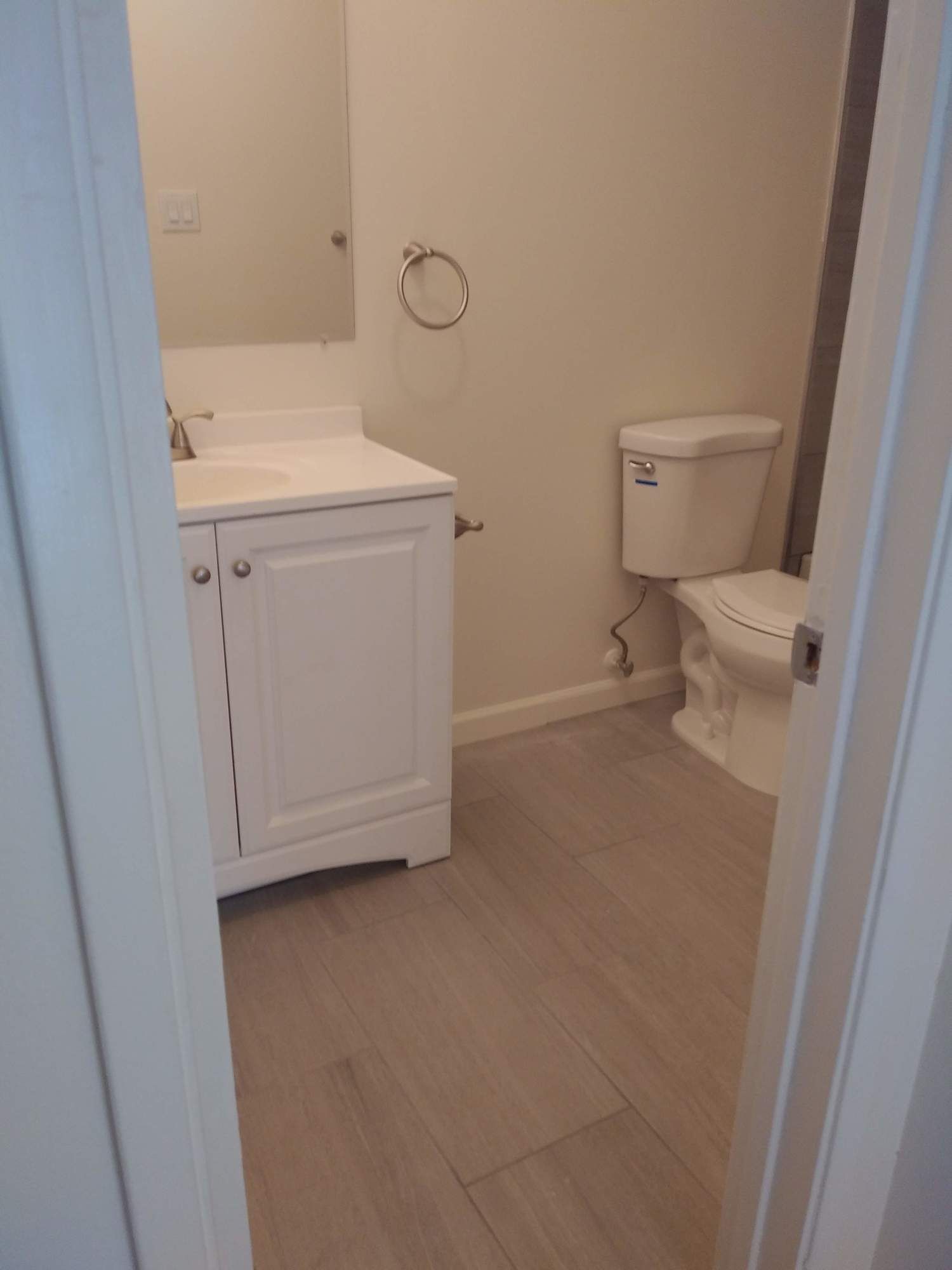 a bathroom with a sink , toilet and mirror .