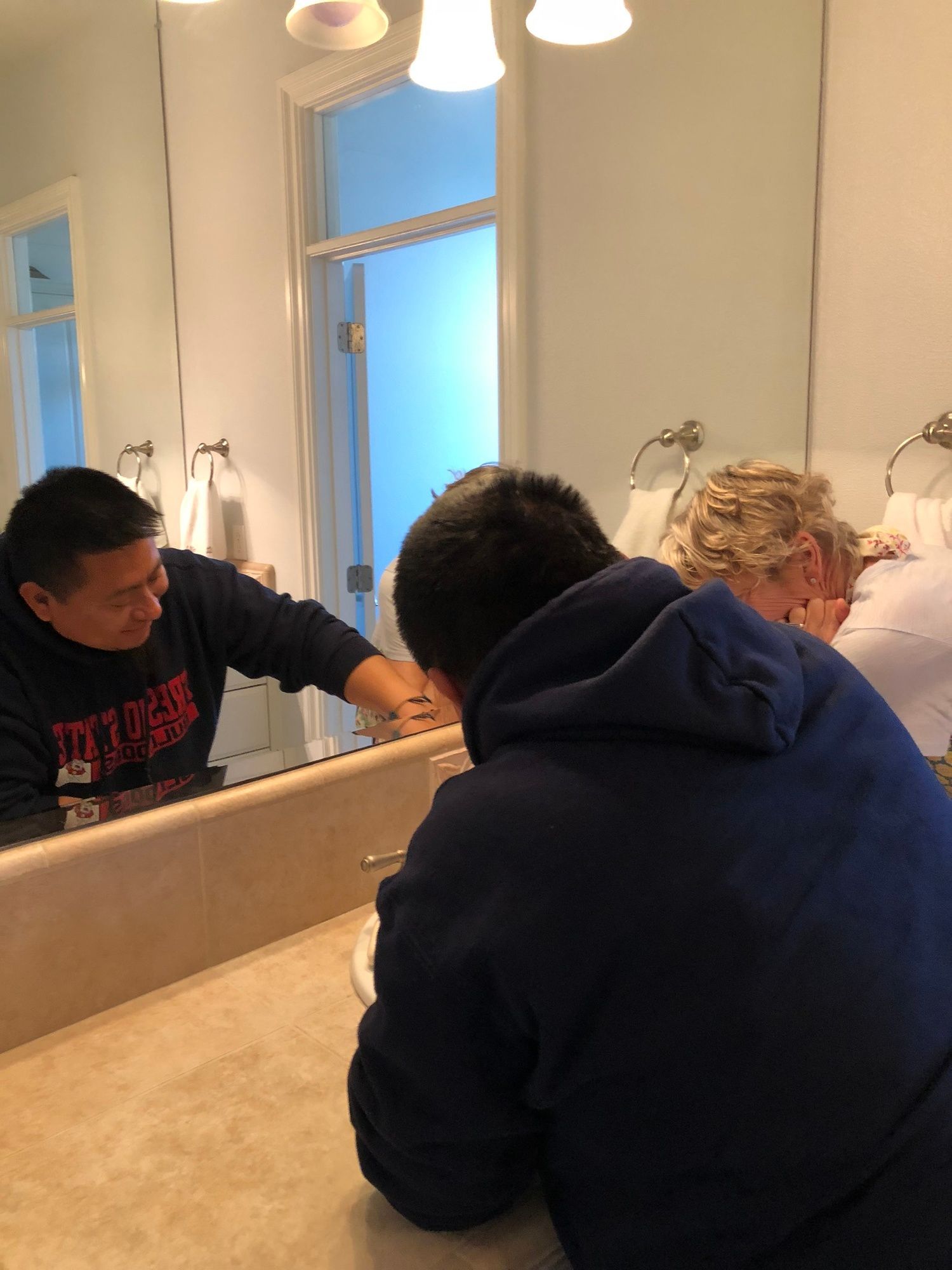 Carlos showing the newly renovated bathroom the owner of the home