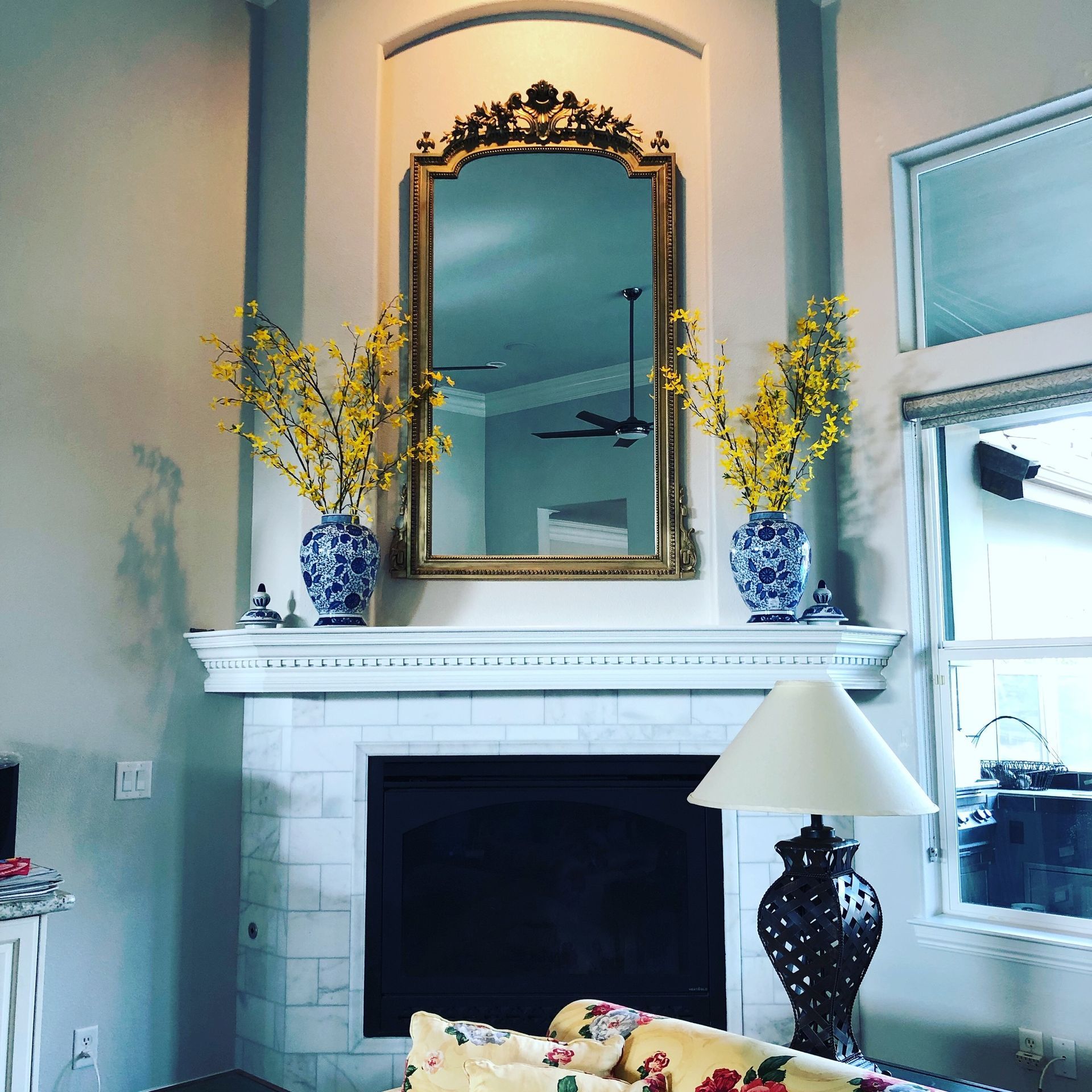 a living room with a fireplace and a lamp