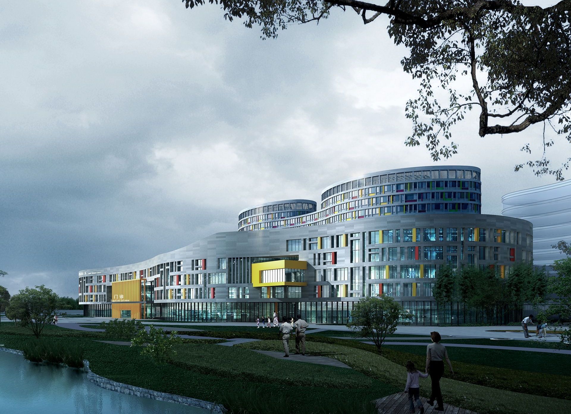 A large building with a lot of windows is surrounded by trees and a body of water