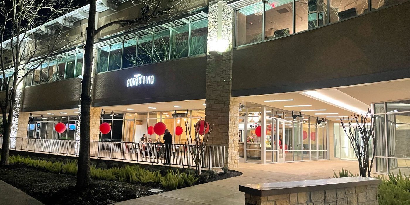 A large building with a lot of windows is lit up at night.