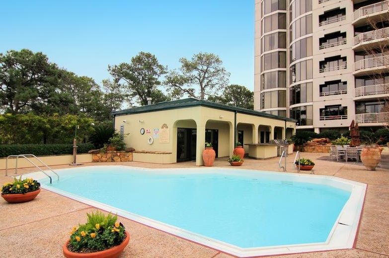 A large swimming pool with a building in the background