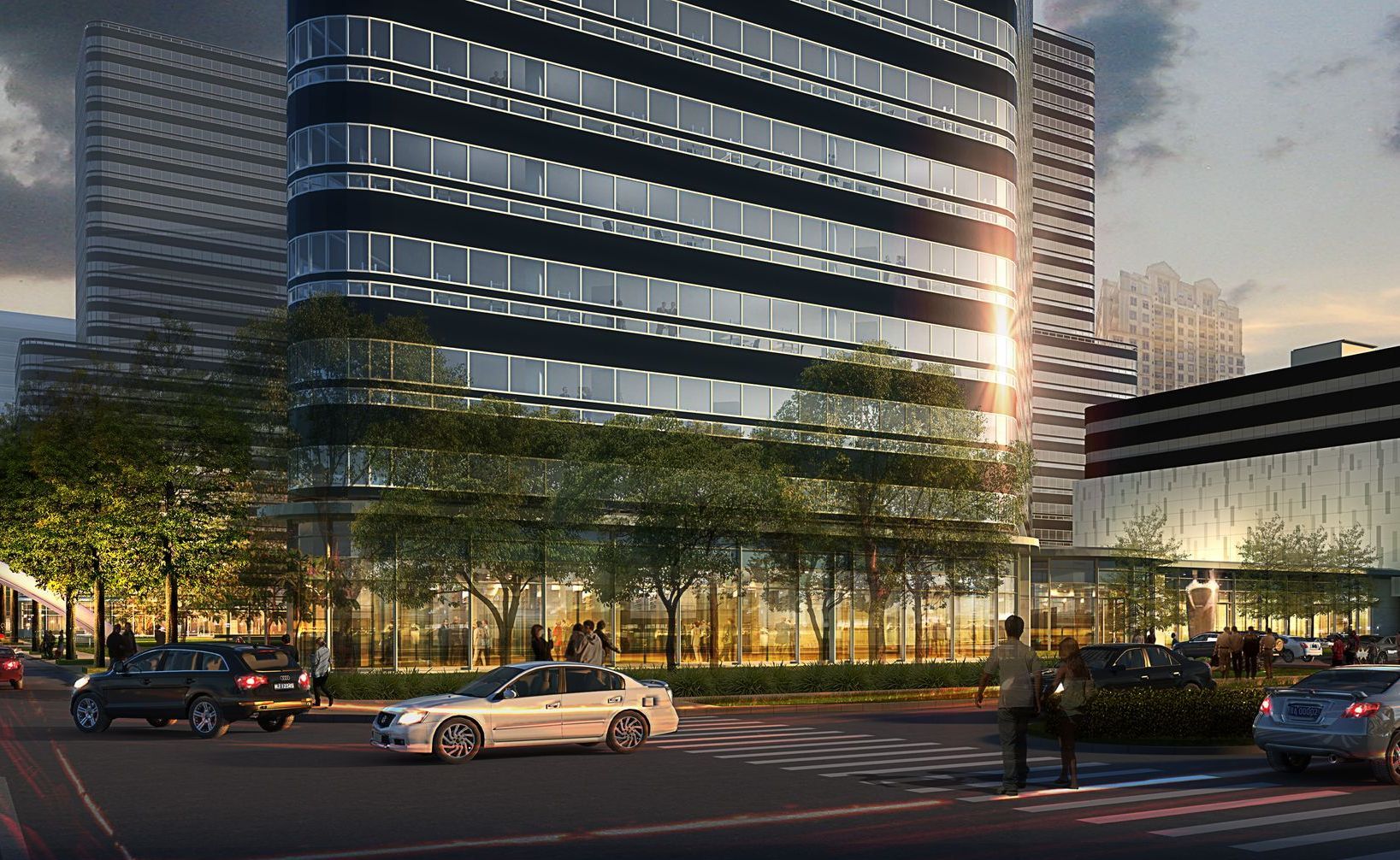 A car is driving down a street in front of a tall building.