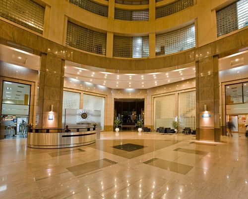 A large lobby of a building with a clock on the wall
