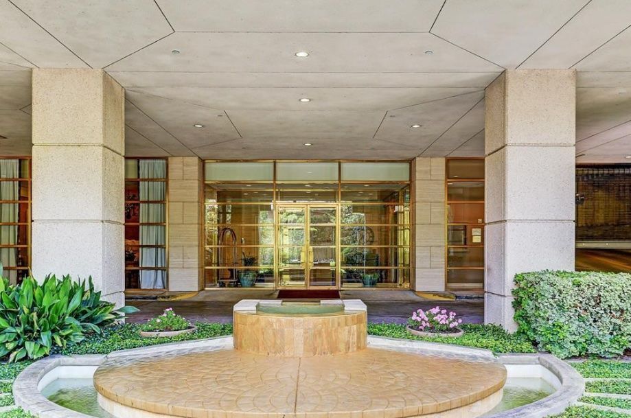 A large building with a fountain in front of it