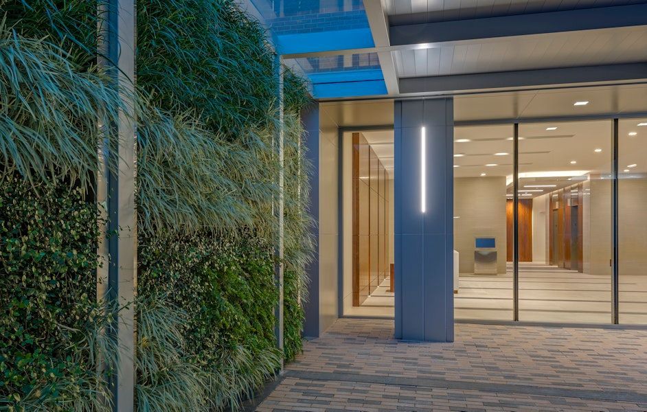 A building with a green wall and a large glass door