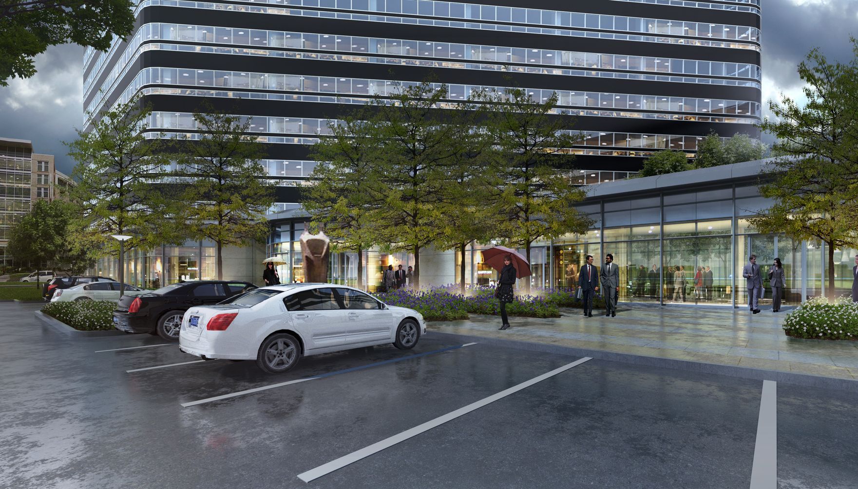 A white car is parked in front of a tall building.