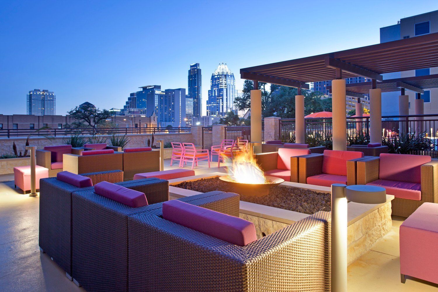 A fire pit with a city skyline in the background