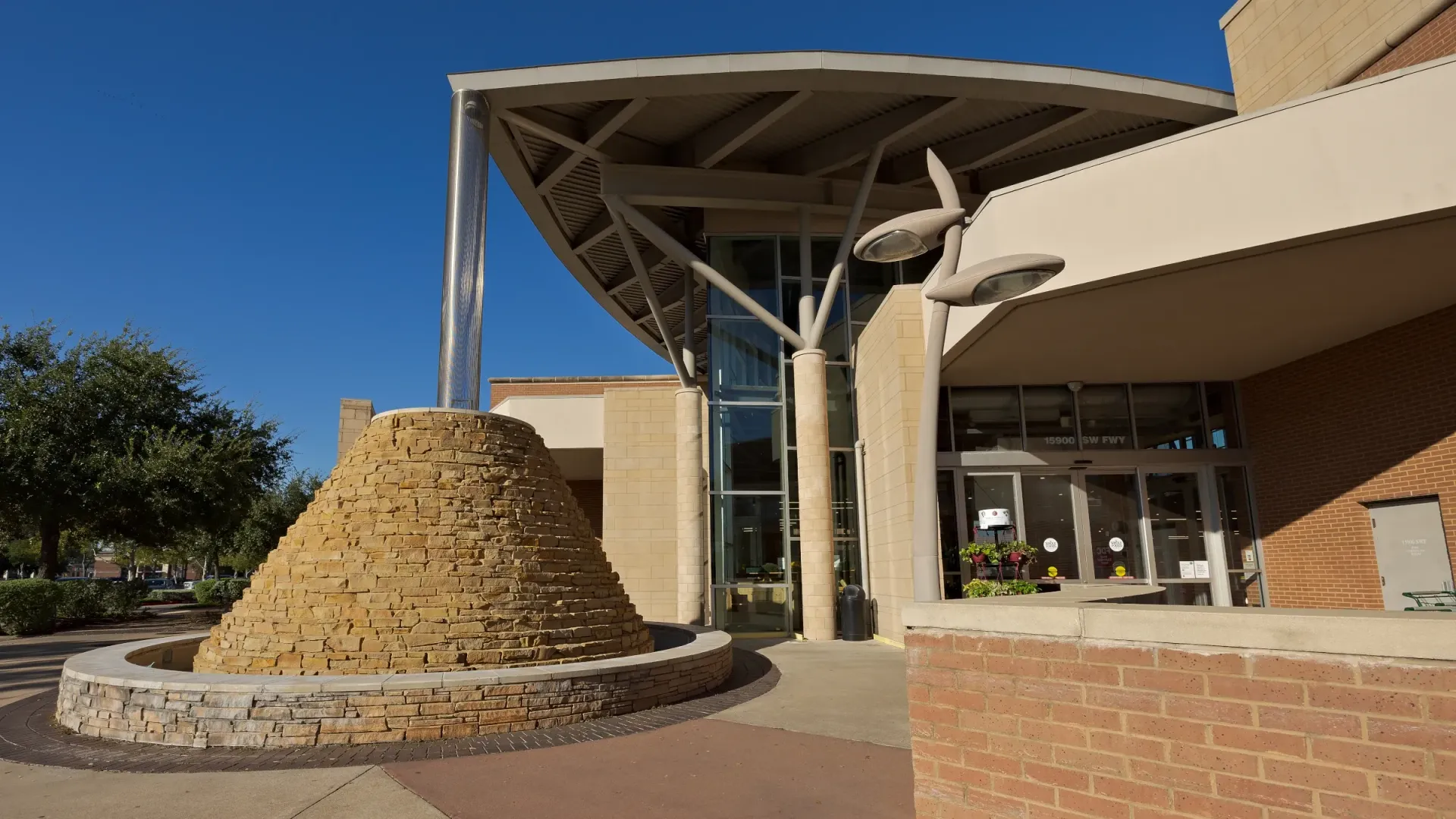 A large building with a large sculpture in front of it