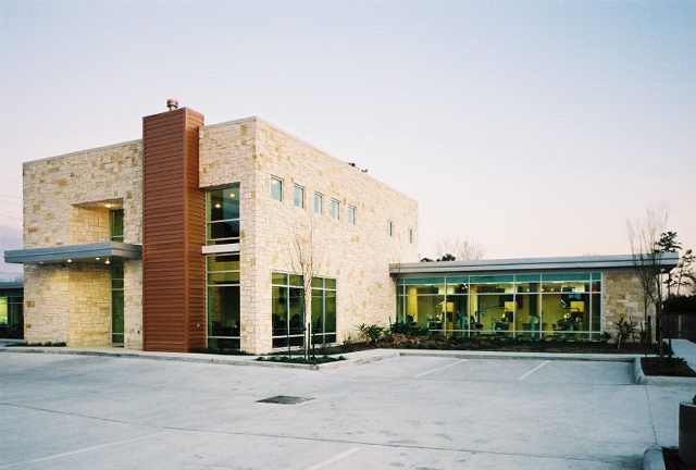 A large building with a lot of windows and a chimney
