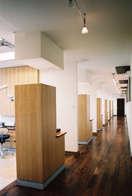 A long hallway in a dental office with wooden cabinets