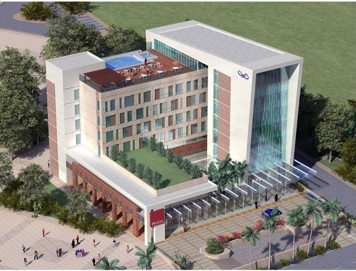 An aerial view of a large building with a pool on top