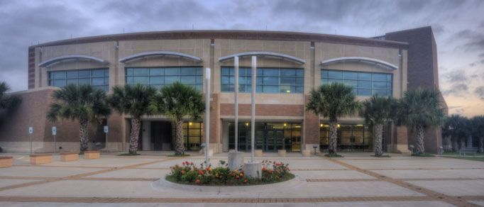 A large building with palm trees in front of it
