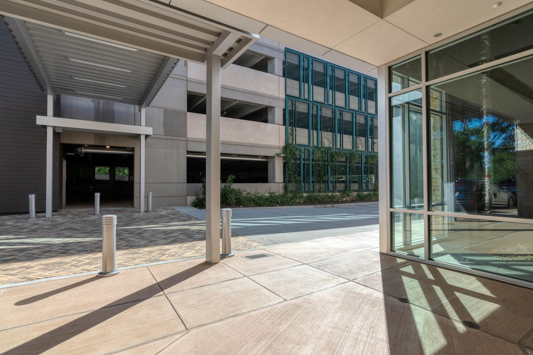 A large building with a lot of windows and a walkway leading to it.