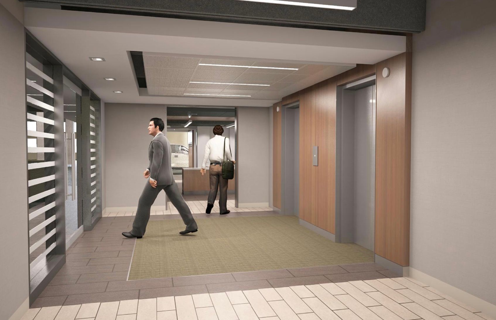A man in a suit is walking down a hallway next to two elevators.