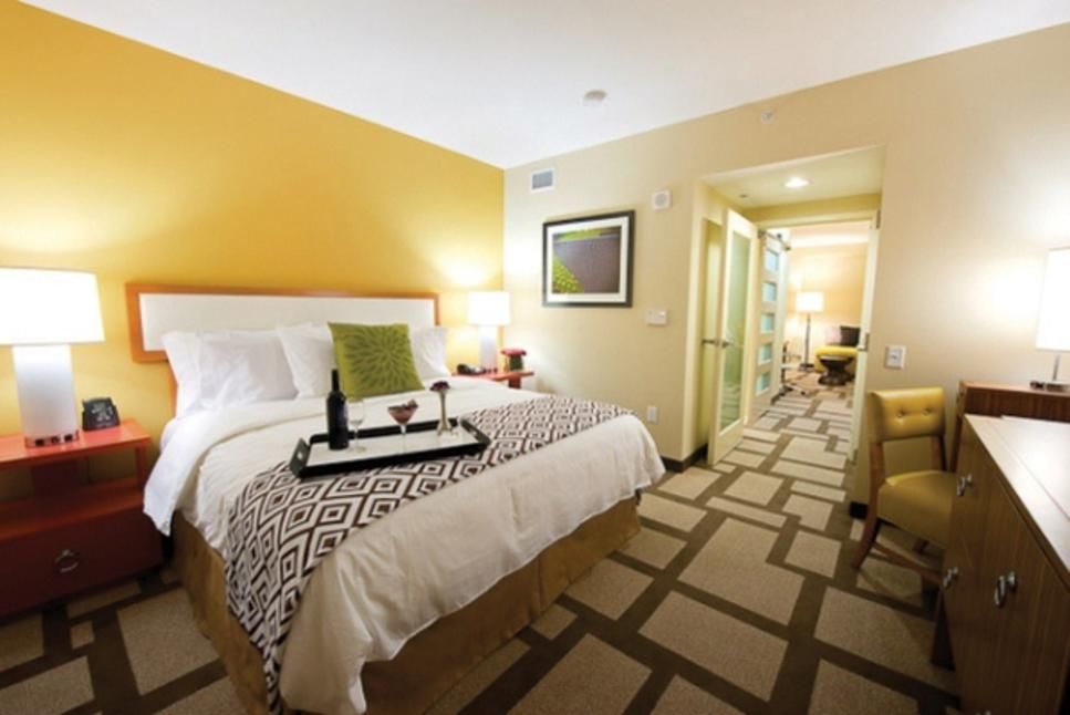 A hotel room with a large bed and a tray on it