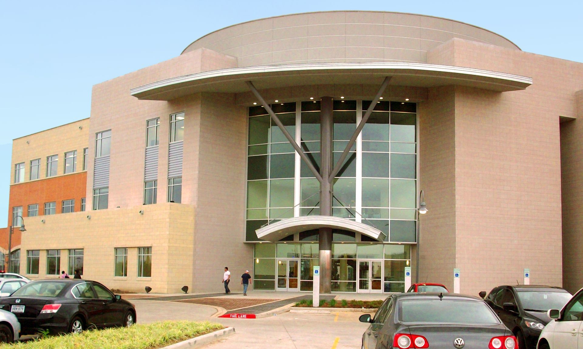 A large building with cars parked in front of it