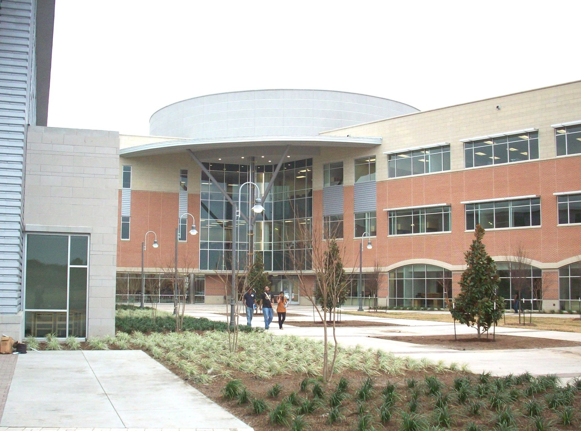 A group of people walking in front of a large building