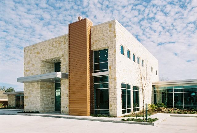 A large building with a lot of windows and a chimney on the side.