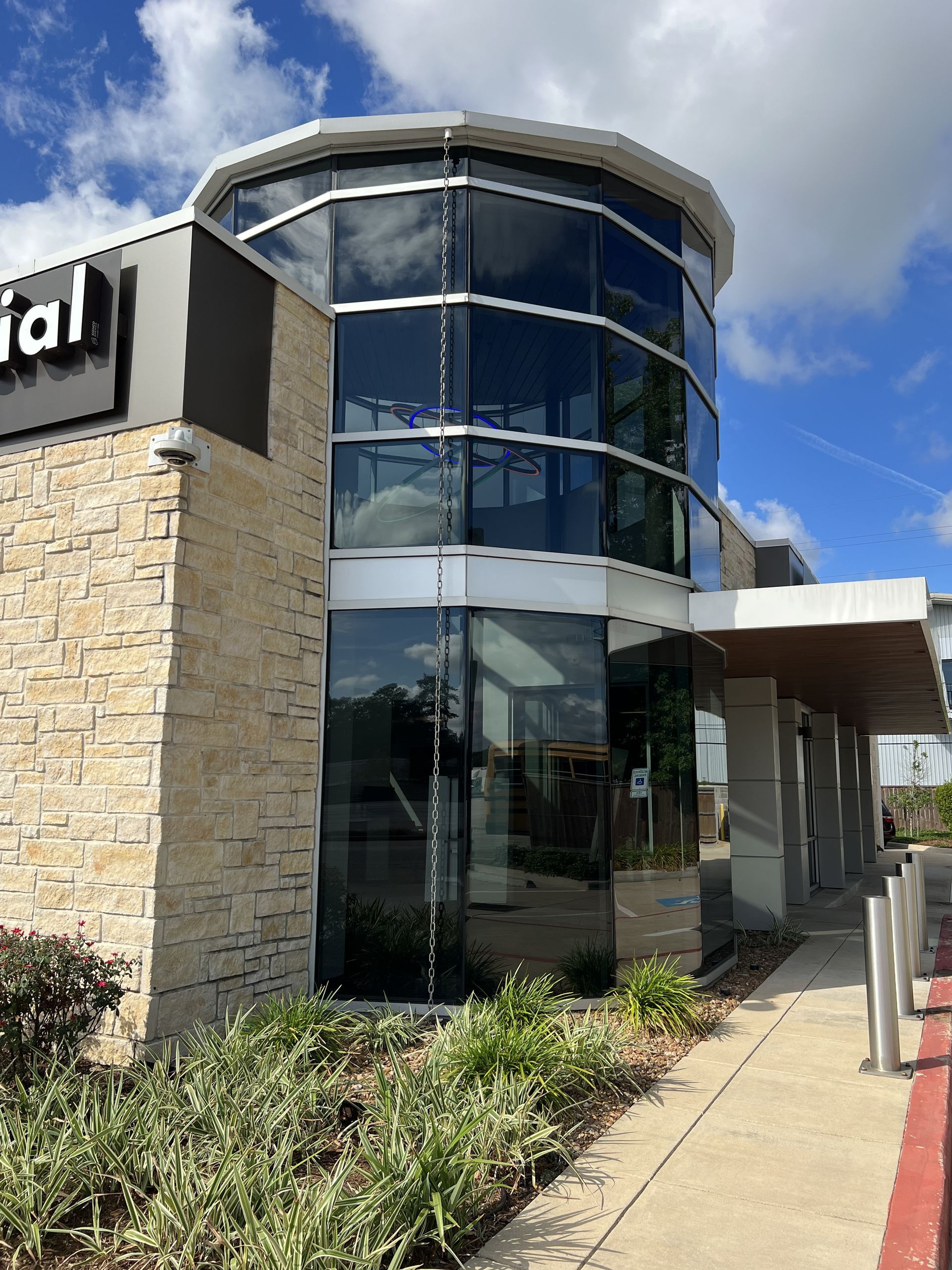 A large building with a lot of windows and a sign that says dental