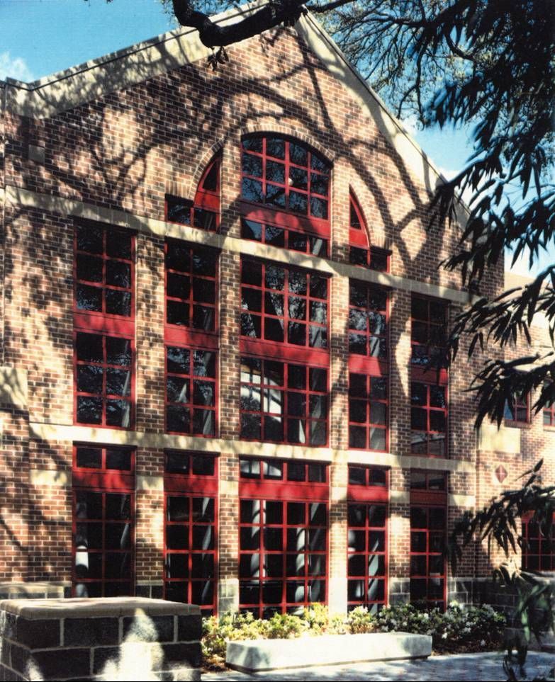 A large brick building with lots of red windows