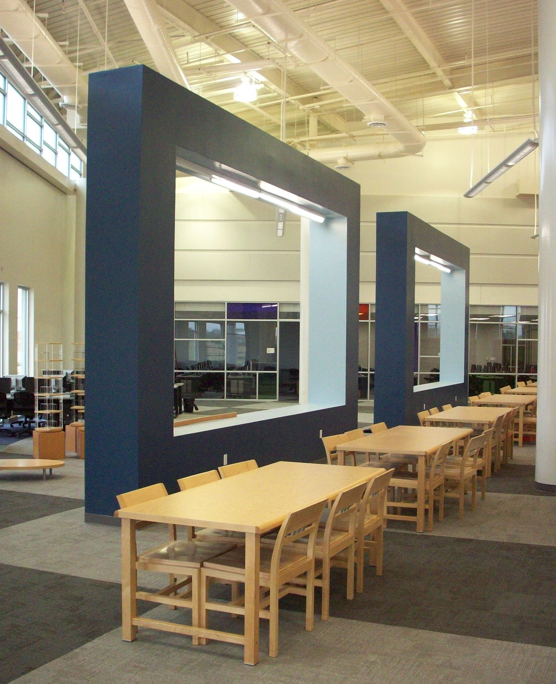 A large room with tables and chairs in it