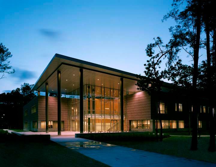 A large building with a lot of windows is lit up at night